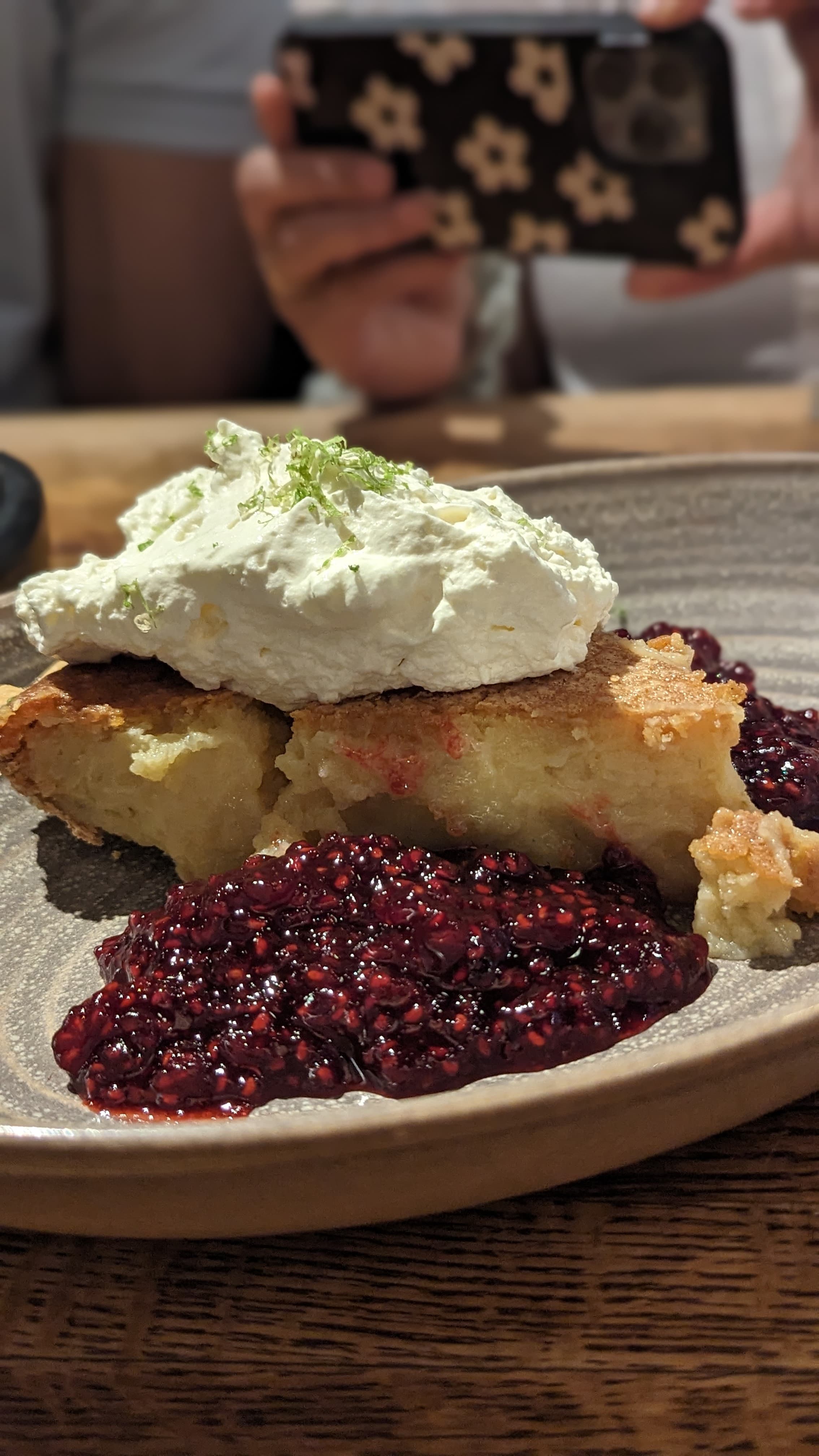 A dessert with berries and cream
